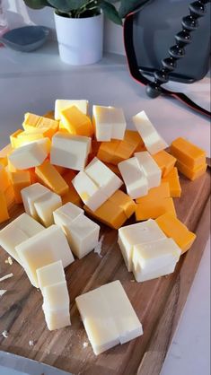 several pieces of cheese are on a cutting board
