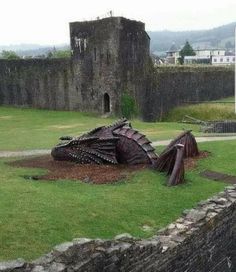 there is a large sculpture in the middle of this field that looks like it has fallen down