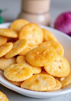 a white plate filled with fried food on top of a table next to an onion