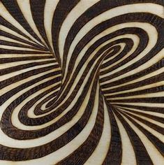 an image of a swirl pattern made out of wood