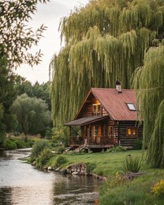 a log cabin sits on the bank of a river