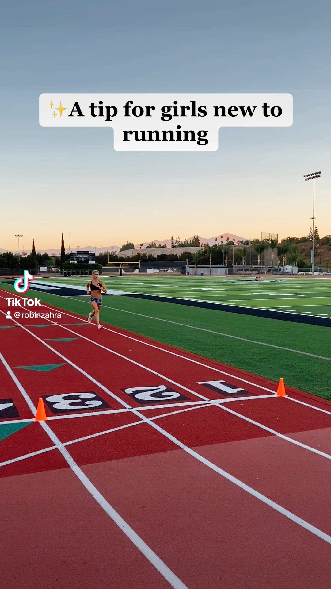 This contains: Girl in sports bra and shorts running around the track and sprinting on turf field. Husband and wife running together. Running fitness