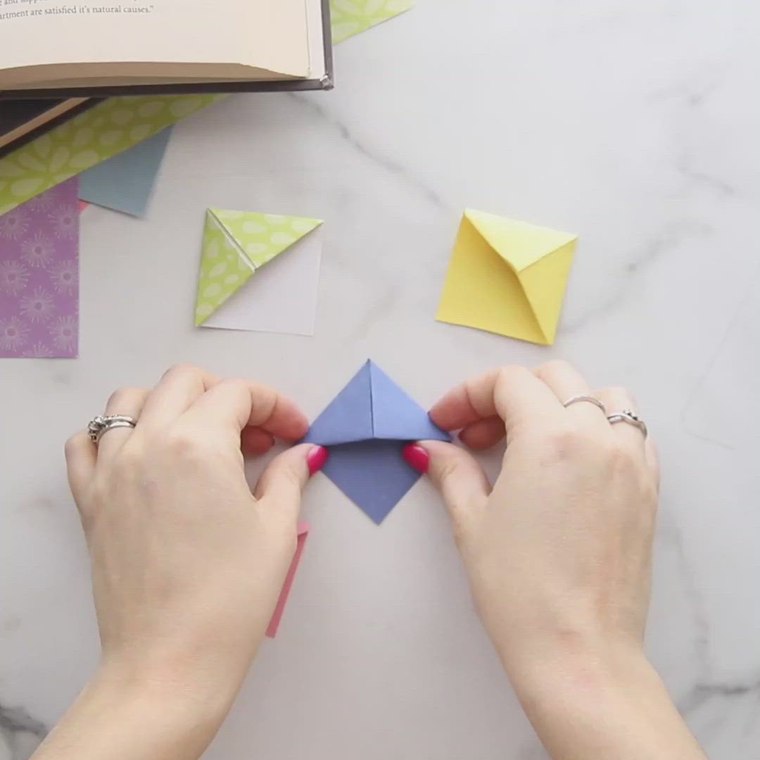 This may contain: someone is making origami pieces out of paper
