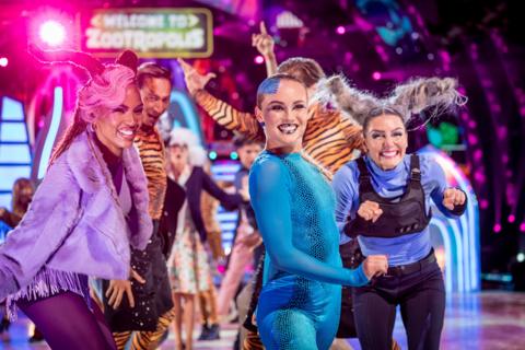 3 pro dancers dressed in colourful costumes
