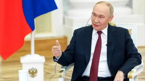 Putin gestures with his right hand