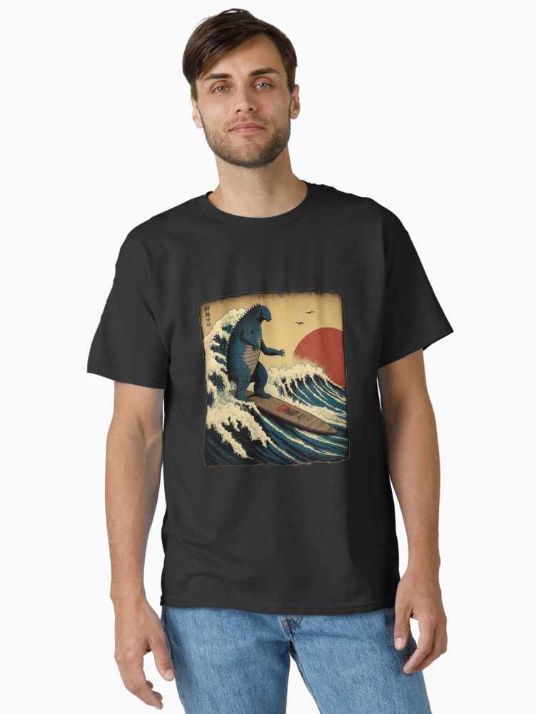 Imagen 2 de 7, Camiseta clásica con la obra Godzilla surfeando la gran ola de Hokusai Divertida parodia, diseñada y vendida por ShakethaRobin.