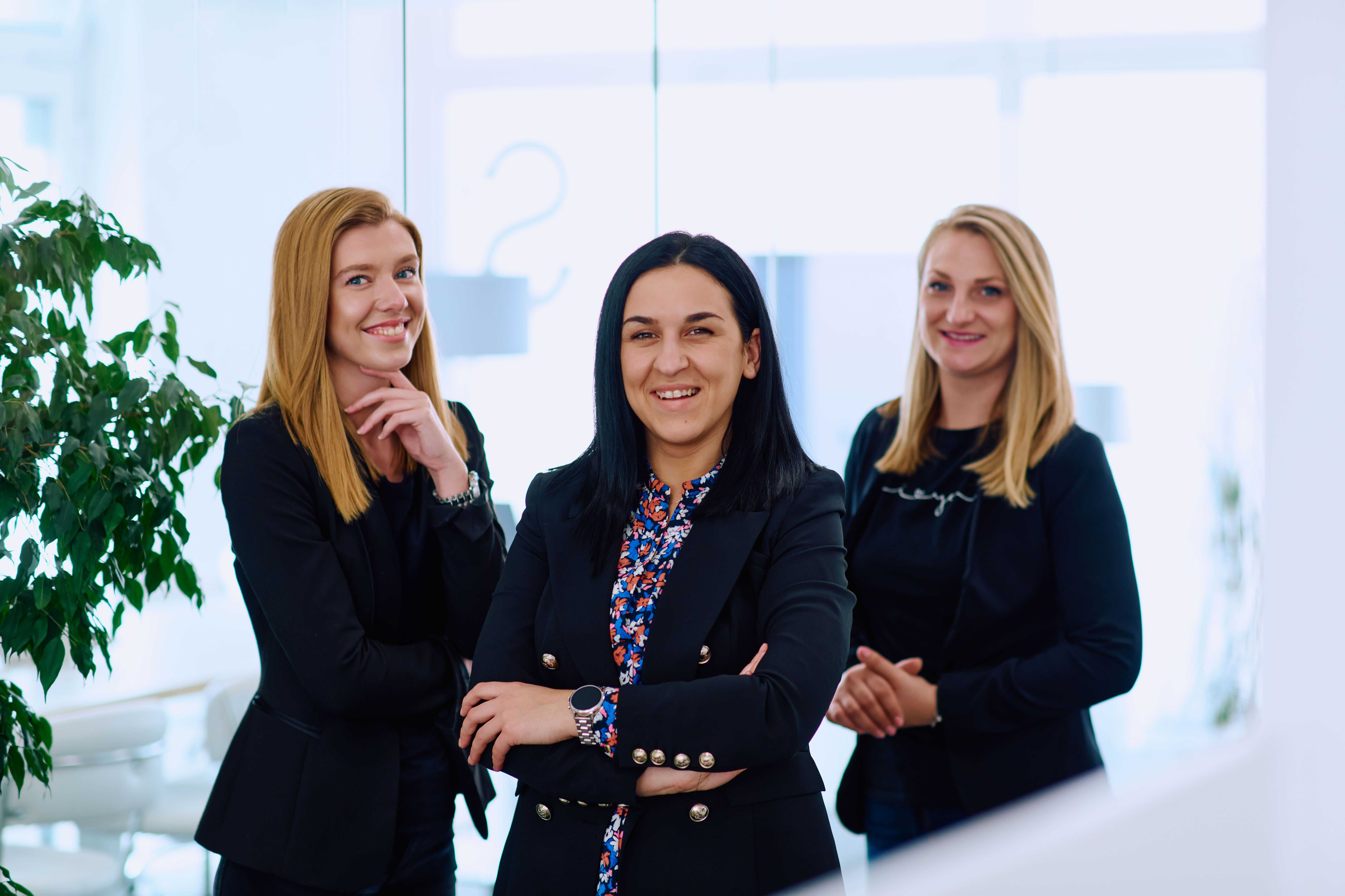 A group of businesswomen in a modern office setting