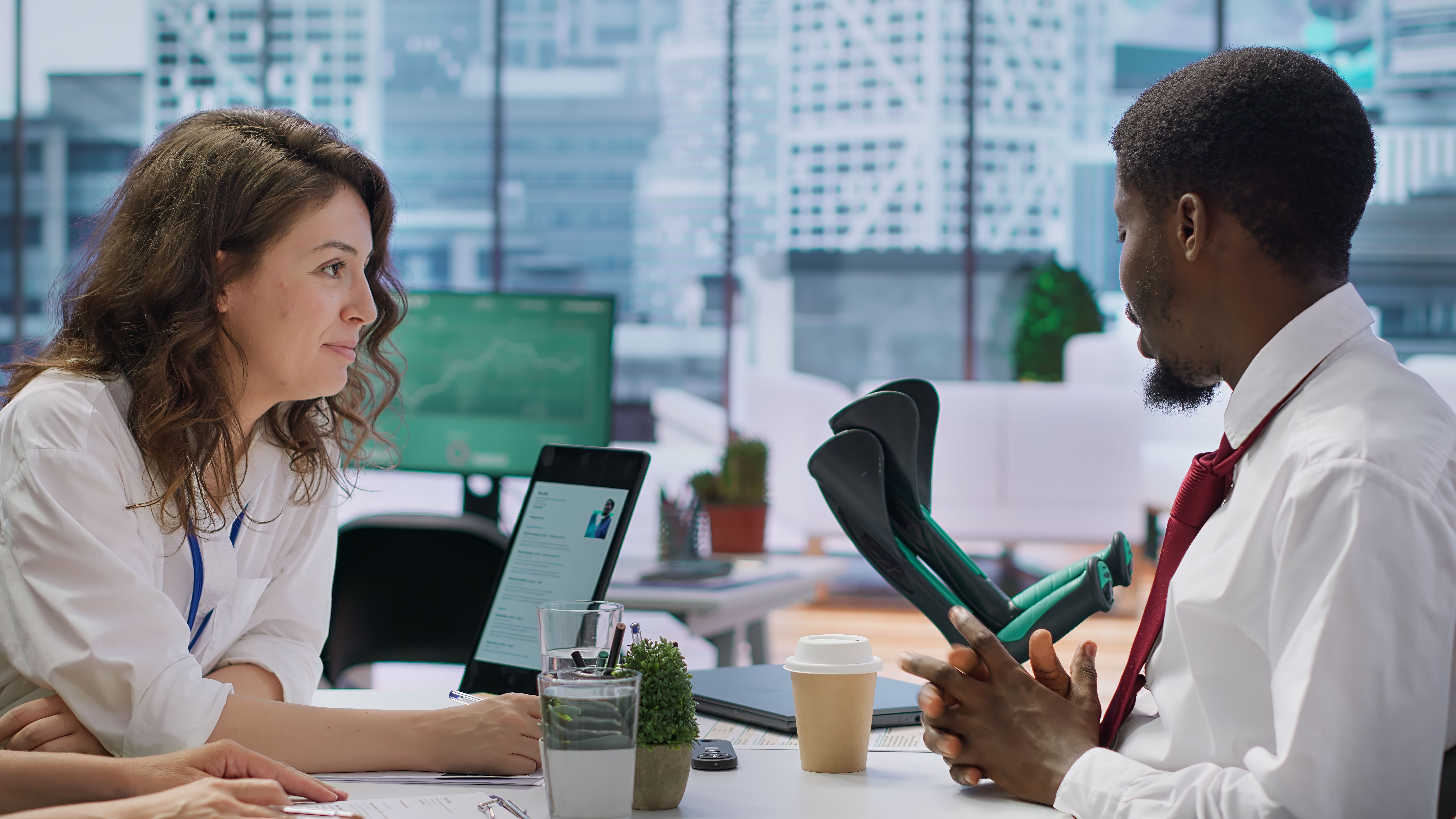 A human resource recruiters team interviewing a candidate and discussing company benefits