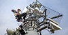 A technician climbing a cellphone tower