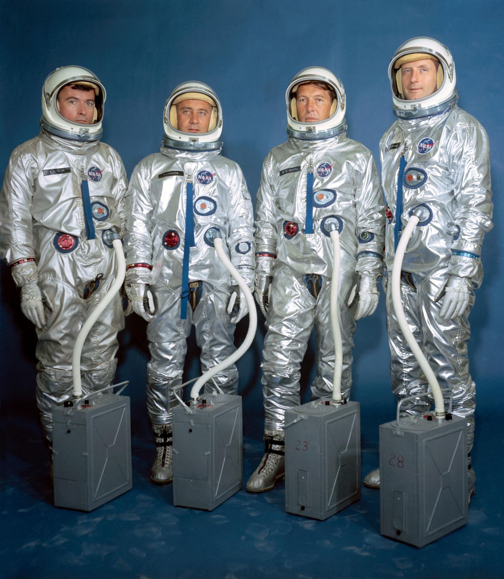 Four Gemini astronauts standing together in their silver space suits.