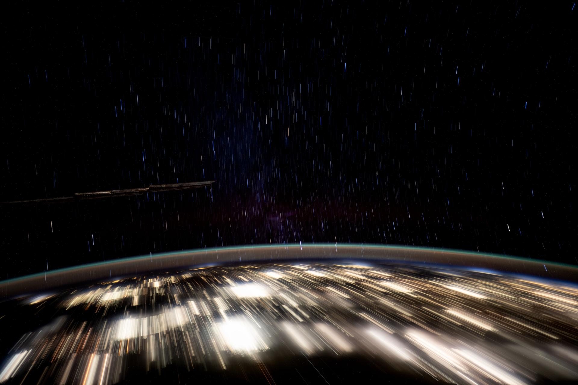 This long-duration photograph highlights the city lights of Mexico's Yucatan peninsula, Earth's atmospheric glow, and star trails above taken from the International Space Station as it orbited 258 miles above.
