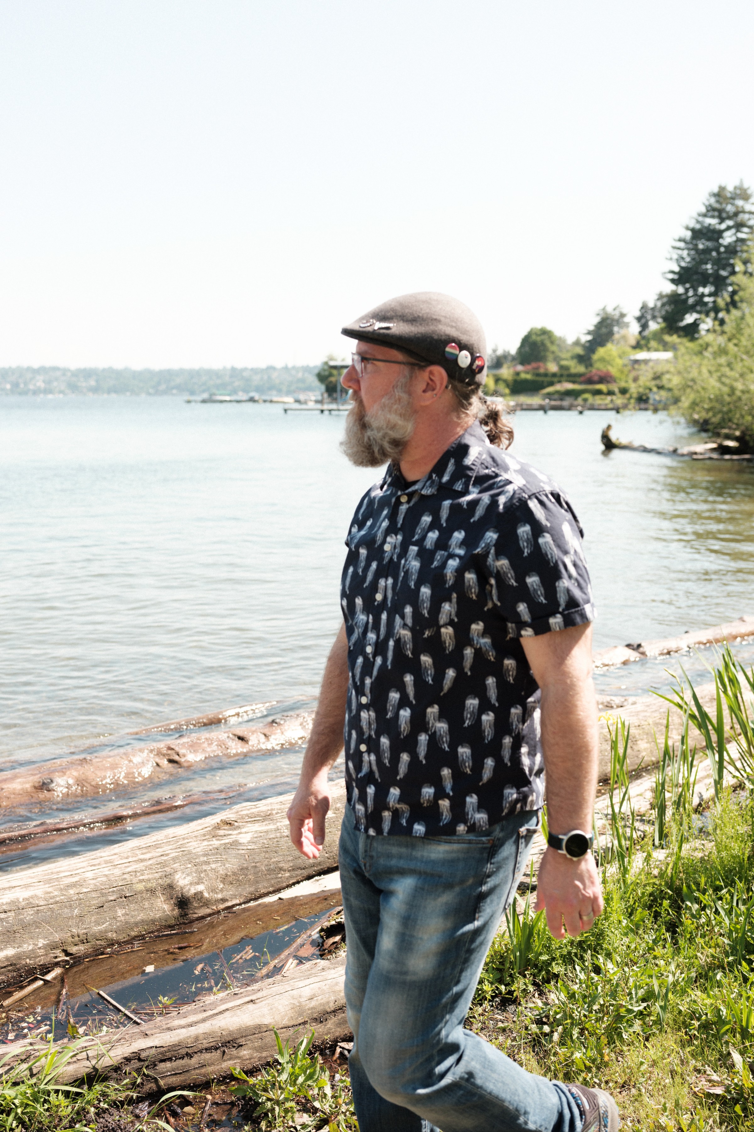Aaron enjoys a walk near the water's edge as logs float nearby.