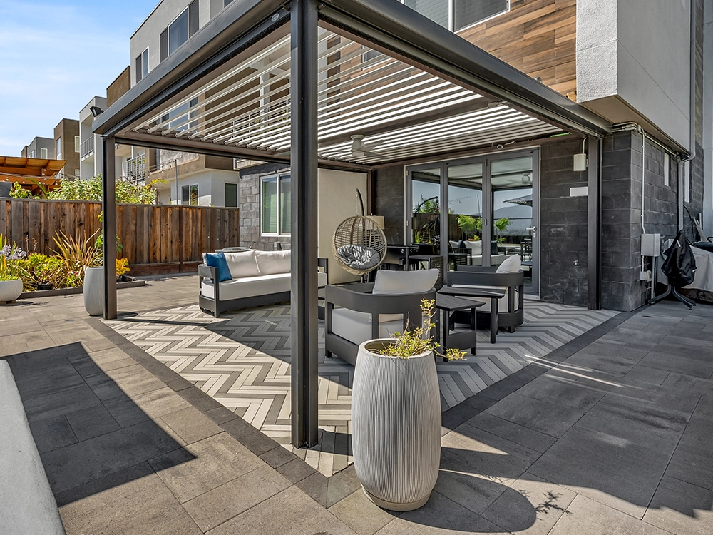 All season pergola over a paver patio.