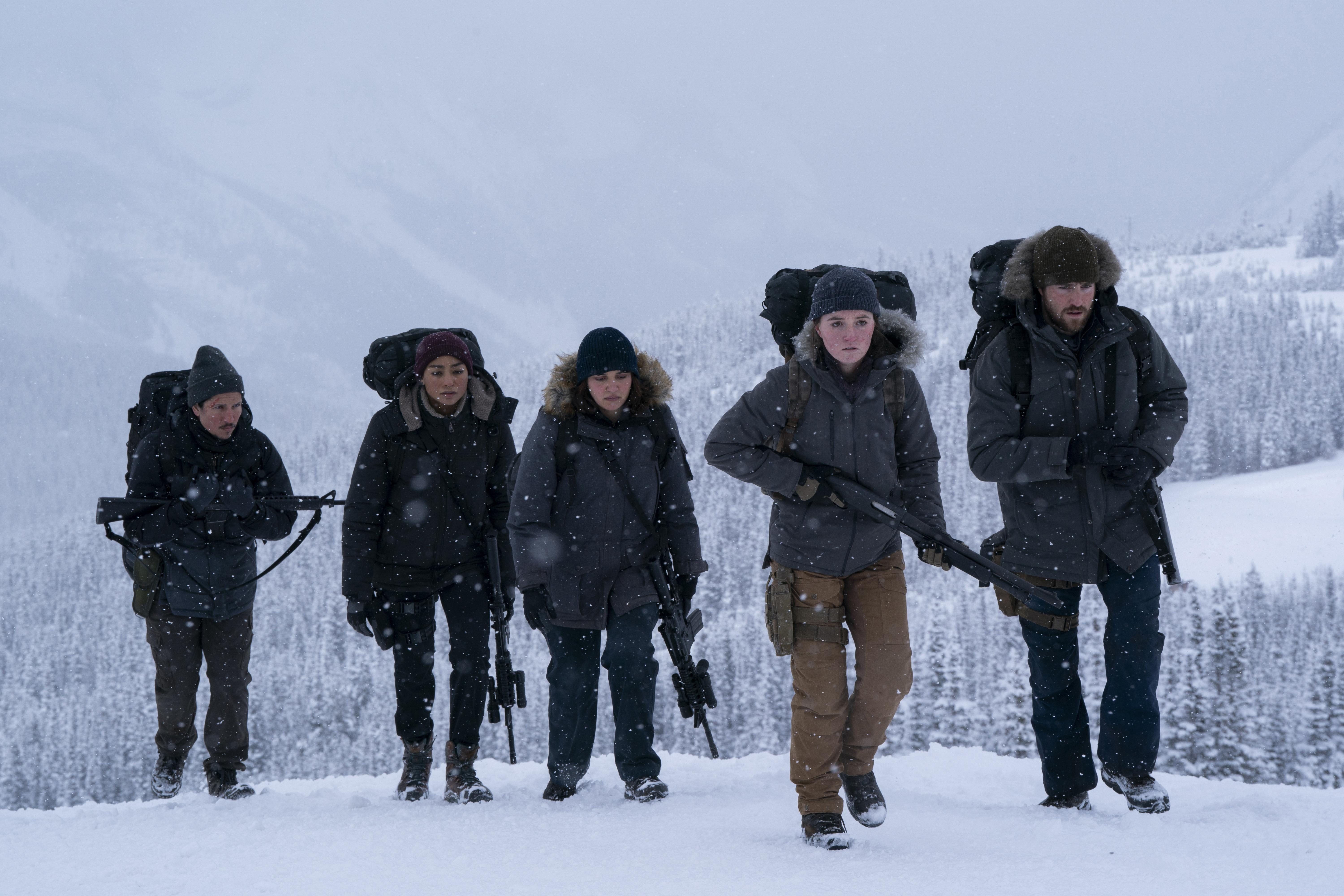 The Last of Us Danny Ramirez as Manny, Tati Gabrielle as Nora, Ariela Barer as Mel, Kaitlyn Dever as Abby and Spencer Lord as Owen in The Last of Us walking in the snow