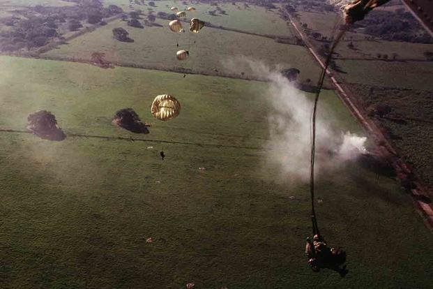 Soldiers of 1st Battalion, 509th Infantry, parachute from a C-130E Hercules aircraft into a drop zone outside the city to conduct operations in support of Operation Just Cause. (National Archives/Master Sgt. Ken Hammond)