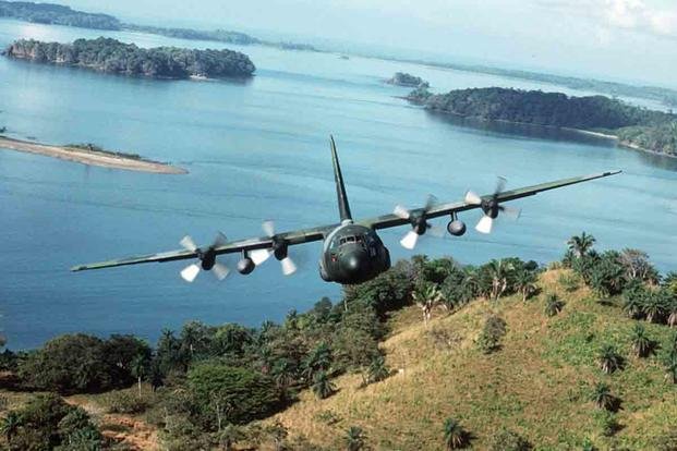 A C-130E Hercules aircraft from the 934th Tactical Airlift Group, U.S. Air Force Reserve, flies along the coast while returning to Howard Air Force Base, Panama, during Operation Just Cause. (National Archives/Master Sgt. Ken Hammond)