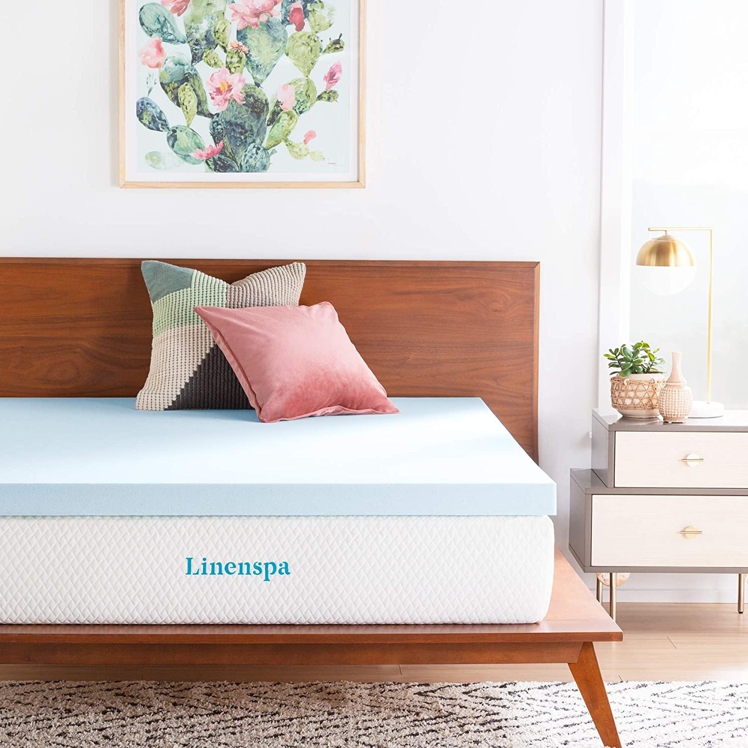 blue two-inch memory foam topper on a mattress