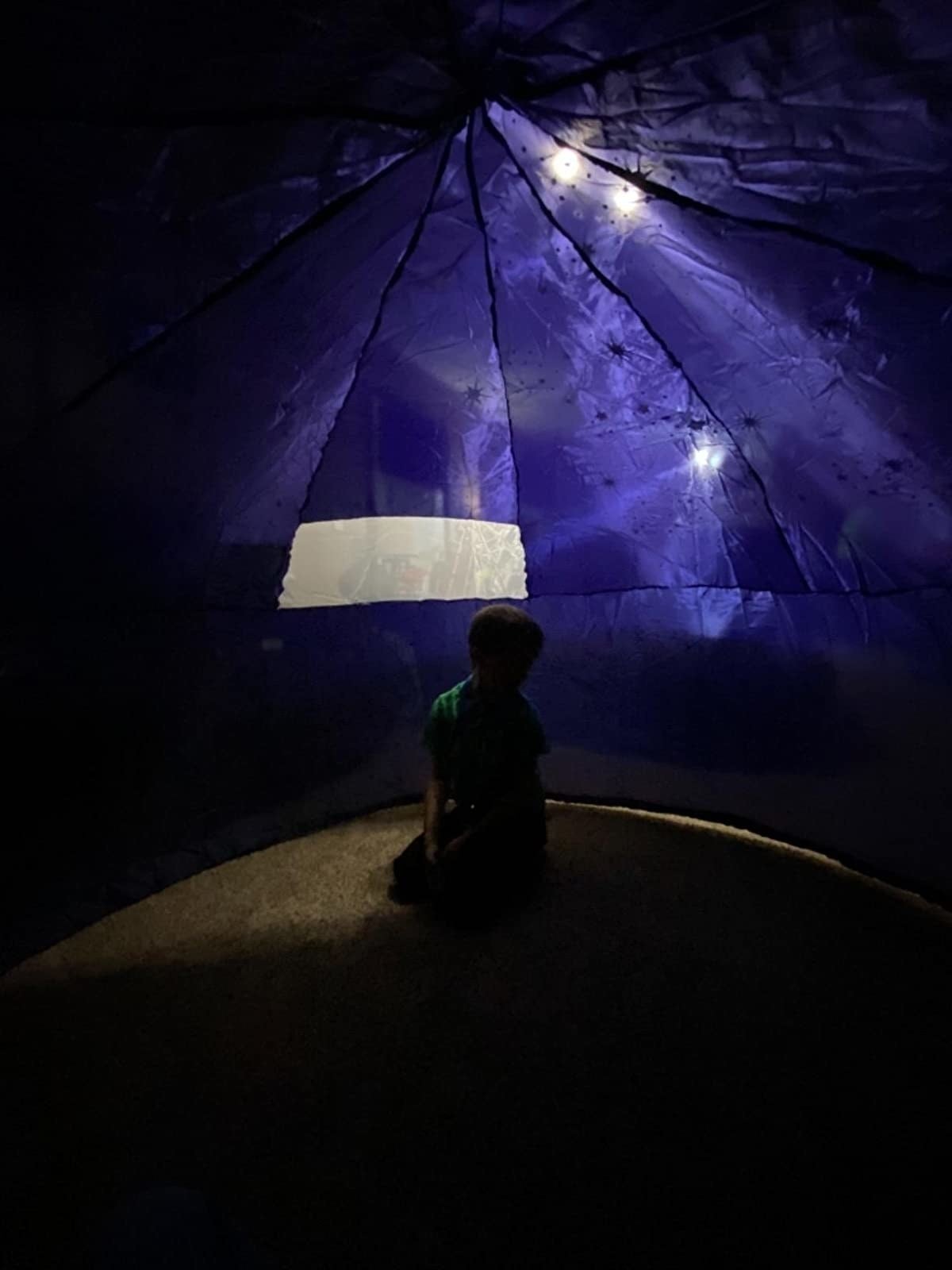 child sits in air fort
