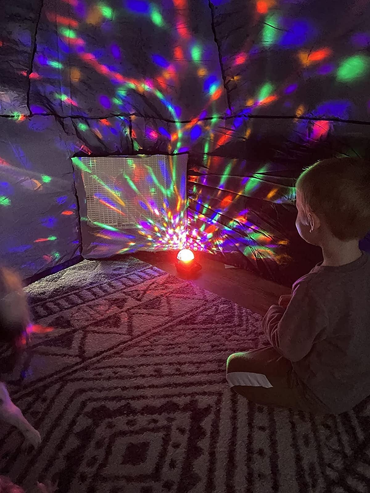 different child sits in air fort