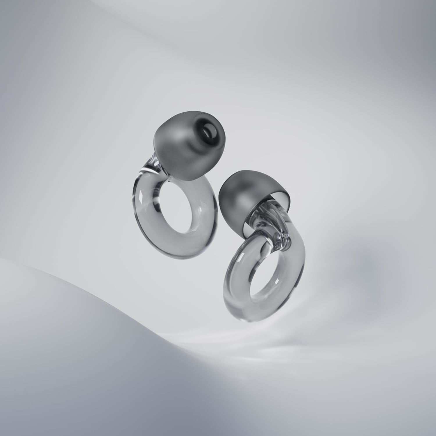 Two modern, clear loop-shaped earbuds on a smooth white background
