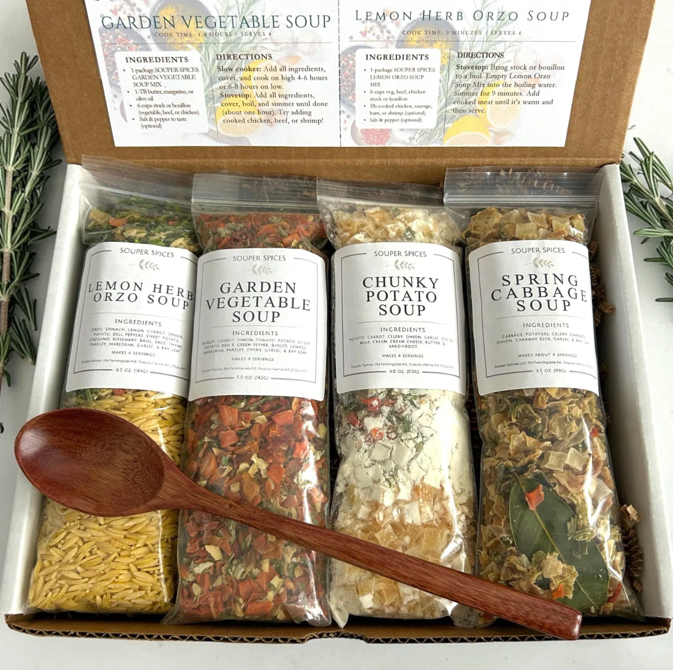 Package of four soup mixes with a wooden spoon, featuring flavors like lemon herb orzo, garden vegetable, chunky potato, and spring cabbage