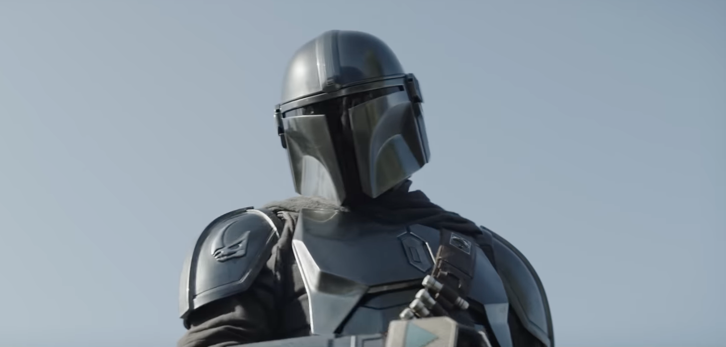A character in futuristic armor and helmet looks ahead against a clear sky, evoking a sci-fi or fantasy setting