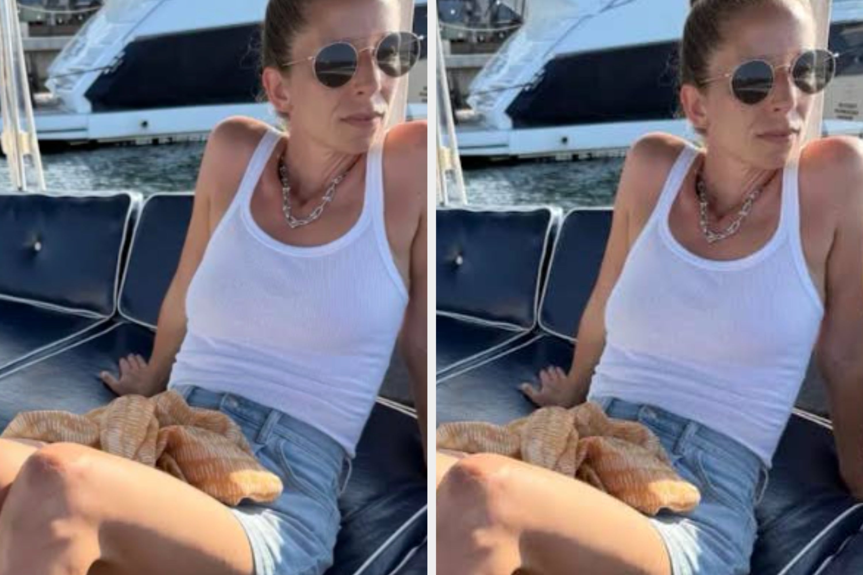 Person on a boat wearing a white tank top, denim shorts, and sunglasses, with a chain necklace. Relaxed pose with yachts in the background
