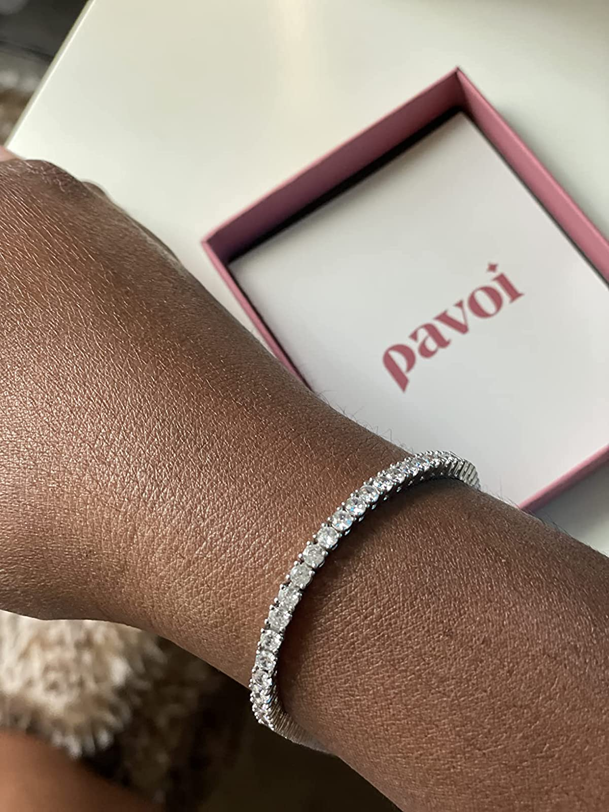reviewer wearing the silver bracelet on their wrist