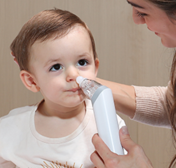 Woman using a nasal aspirator on a baby to clear the child's nasal passages, highlighting its use in home healthcare