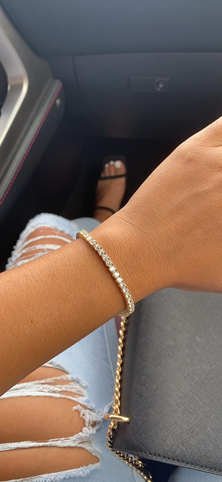 reviewer wearing the gold bracelet on their wrist
