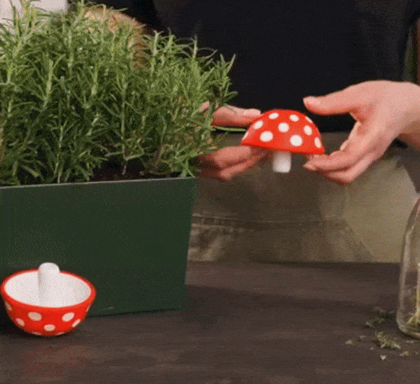 gif of someone flipping the mushroom funnel inside out and using it to pour oil into a bottle
