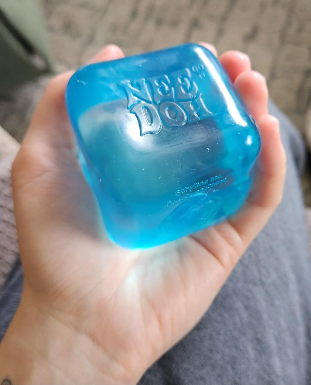 reviewer holding the blue version in their hand 