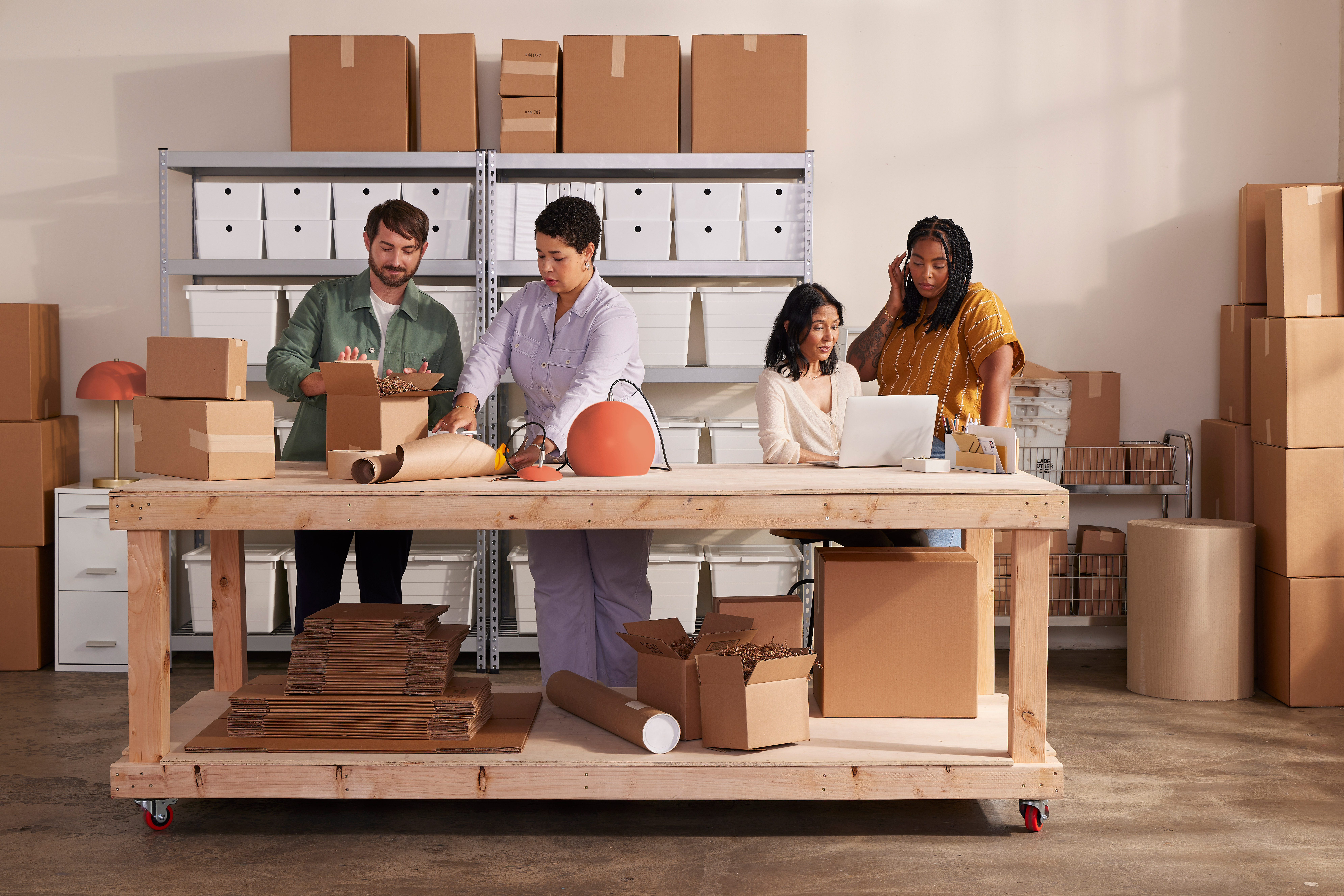 4 people boxing packages