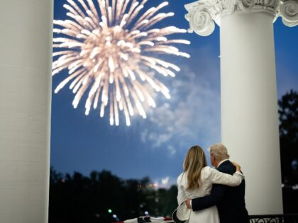 President Donald Trump and First Lady Melania Trump watch fireworks from the Truman Balcon