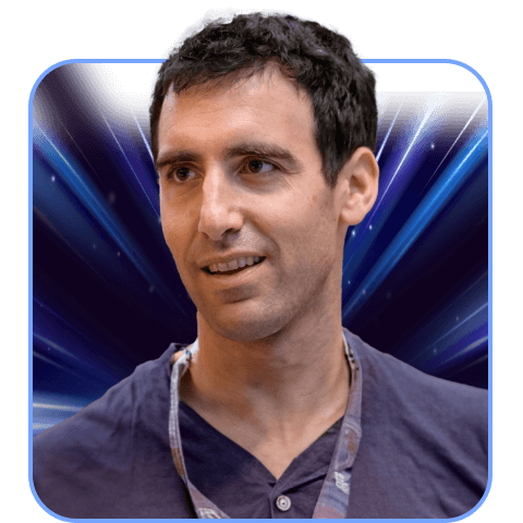Person with a dark blue background, wearing a lanyard.