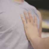 a close up of a person 's hand on a man 's chest