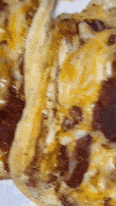 a close up of a pizza with bacon and cheese