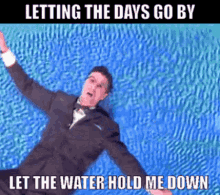 a man in a suit is floating in a pool with the words letting the days go by let the water hold me down below him
