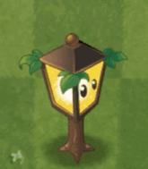 a cartoon lantern with a palm tree on top of it is sitting on top of a grass covered field .