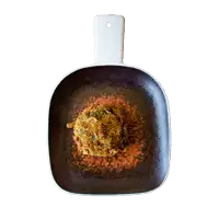 a pan with a white handle and a piece of food on top