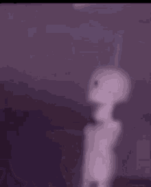 a close up of a purple background with a blurred image of a person 's face