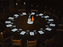 three small flags are on a table including one from the united states
