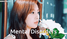 a woman with mental disorders is holding a white flower
