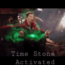 doctor strange is sitting in a chair with a green light coming out of his chest and says time stone activated