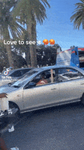 a car with a person sitting in the driver 's seat is driving down the road .