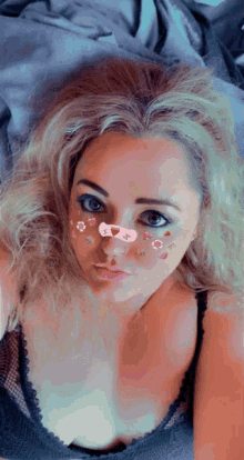 a woman with flowers on her face is laying down