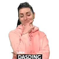 a woman wearing a pink hoodie with swr dasding on the sleeve