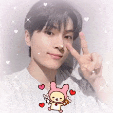 a young man is making a peace sign with his fingers surrounded by hearts and a cartoon character .
