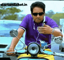 a man wearing sunglasses and a purple shirt is riding a scooter with the website starttamilchat.in written below him