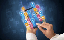 a person is holding a cell phone with a bunch of icons on it .